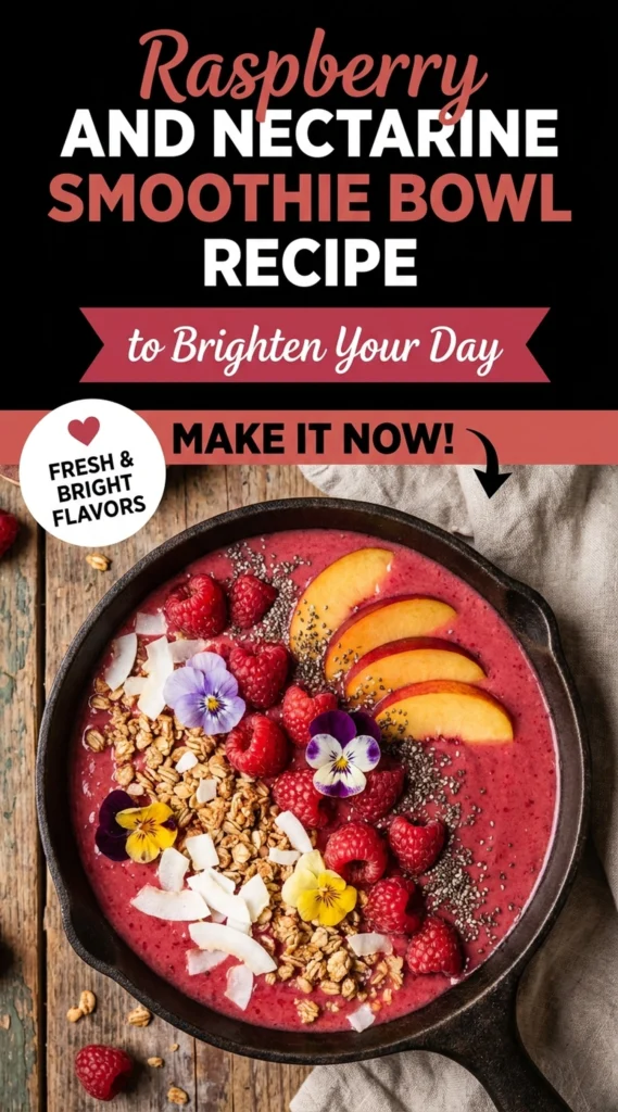 A pink raspberry and nectarine smoothie bowl topped with fresh berries, sliced nectarines, granola, and mint leaves.